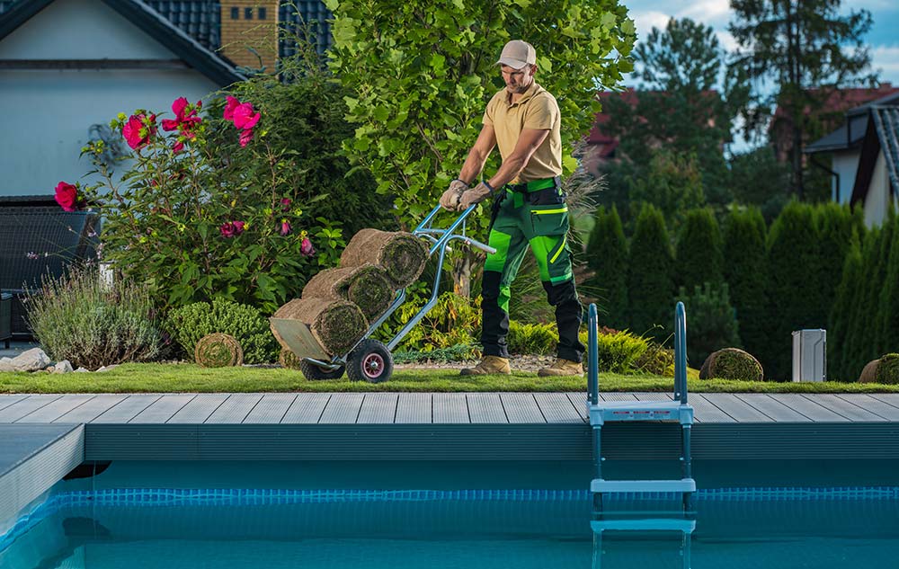 landscaper-in-his-40s-moving-natural-grass-turfs-resize.jpg